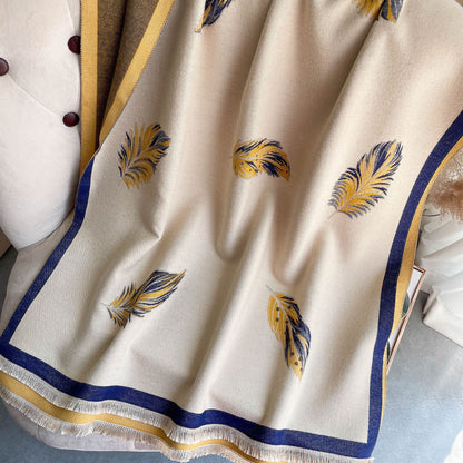 Beige fabric with feather patterns and blue and gold borders on a textured surface.