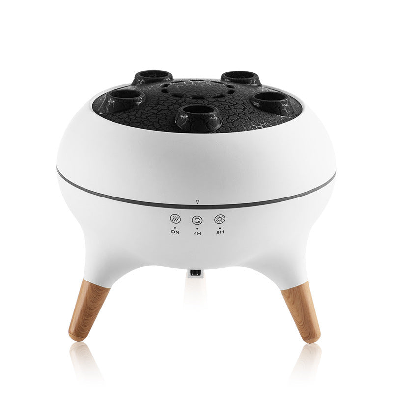 White electronic device with wooden legs and black top on a white background