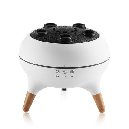 White electronic device with wooden legs and black top on a white background