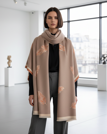 Woman wearing a beige scarf with floral patterns in a modern indoor setting
